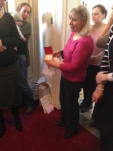 Christina Opens Gift Of Earrings From Her Adams Harrison Colleagues