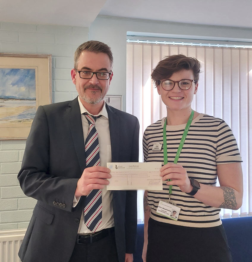 Richard Booth presents cheque donation to Ellie Weatherly from Arthur Rank Hospice Charity
